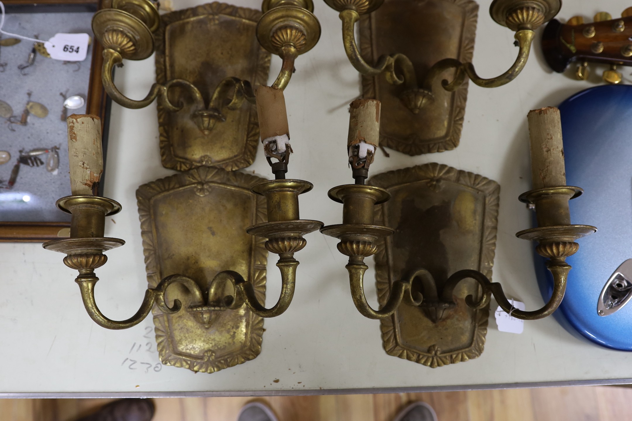 A set of four brass wall sconces